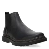 Botas Chelsea de hombre, color negro, confeccionadas en cuero liso. Presentan elásticos laterales para ajuste y una suela gruesa de goma con relieve y entresuela marrón.