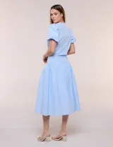 Falda midi abotonada de textura gofrada y diseño a rayas. Presenta cintura ancha entallada, abotonadura frontal completa, corte con frunce para mayor amplitud y bolsillos laterales funcionales. Cuenta con forro interno.