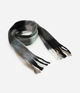 Bufanda larga de punto con estampa cuadriculada en tonos grises, negros y blancos, con flecos en los extremos.