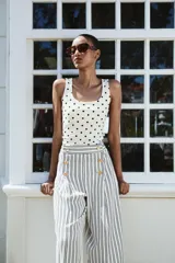 Camiseta blanca ajustada de poliamida con tirantes anchos y escote redondo.