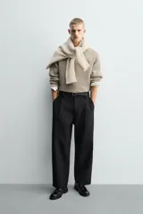 Jersey de punto con diseño boxy fit, cuello redondo y manga larga. Presenta una textura acanalada y acabados en rib en puños y ruedo.