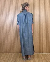 Vestido midi marrón con textura sutil, cuello alto fruncido, cierre frontal con botones y mangas cortas abullonadas con elástico.