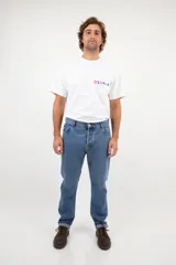 Pantalón jean de corte recto clásico con cinco bolsillos, botones de cobre y costuras color camel.