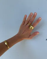 Anillo de metal macizo color plateado con forma orgánica irregular y superficie texturizada.