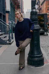 Jersey de punto liso color azul marino, con cuello redondo y manga larga. Acabados en rib.