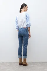 Jean cropped color azul medio, de corte ajustado y ruedo doblado.