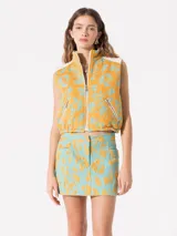 Minifalda celeste con estampado de flores amarillas, tiro bajo, bolsillos frontales y cierre con cremallera.