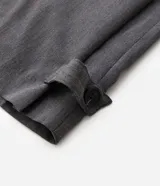 Pantalón de sastrería gris de corte wide leg, con cintura alta, bolsillos laterales y detalles de ajustes con botones en los ruedos.
