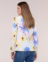 Blazer de silueta semientallada confeccionado en tela sastrera de color blanco con estampado floral en tonos amarillos, celestes, rosados y azules. Presenta solapa de muesca clásica, acceso frontal mediante un botón a tono, bolsillos simulados con solapa y mangas largas de corte clásico.