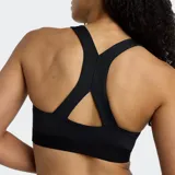 Top deportivo New Balance Essential negro, de soporte medio, con tirantes anchos y espalda deportiva. Presenta el logo NB en el centro del pecho.