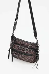 Cartera tipo bandolera con diseño acolchado y estampado animal print. Cuenta con múltiples compartimentos con cierre, correa ajustable con logo y detalle de cadena metálica decorativa y dije colgante con la palabra Lucky.