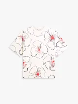Remera de manga corta Tommy Hilfiger de corte relajado, color blanco con estampado floral de contornos azul oscuro y detalles en rojo. Presenta cuello redondo y diseño holgado.