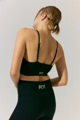 Short deportivo negro de tejido de morley con cintura ancha y logo a contratono en la cintura trasera.