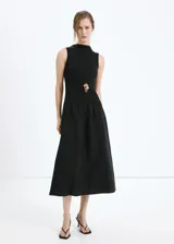 Vestido midi negro sin mangas, con cuello redondo alto y diseño combinado de cuerpo ajustado y falda amplia con vuelo.