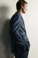 Blazer regular fit azul marino confeccionada en tejido con 20% de lana. Cuenta con cuello con solapas de muesca, manga larga con botones en los puños, bolsillos de vivo en el pecho y de solapa en la cadera, y cierre frontal con botones.