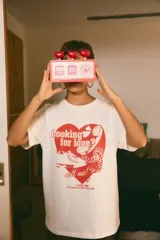 Remerón blanco de algodón con estampado frontal en rojo de un corazón con teléfonos y la frase "Looking for love? call me!" y "The magic is on the line".