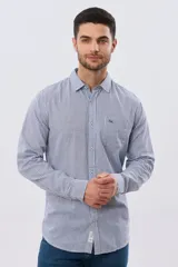 Camisa de lino a cuadros en tonos celeste y blanco, de manga larga, con cuello camisero, cierre frontal con botones y un bolsillo ojal en el pecho con detalle bordado.