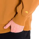 Buzo de cuello redondo color marrón tostado, con logo de Caterpillar estampado en negro en el pecho y detalle de triángulo amarillo bordado en la manga izquierda. Presenta puños y bajo de punto elástico.