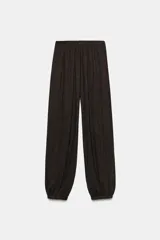 Pantalón bombacho de tiro medio en color gris melange, con cintura y puños elásticos.