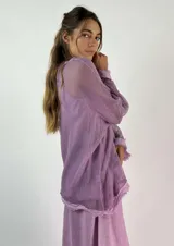 Top gris de malla con capucha, escote en V y mangas anchas.