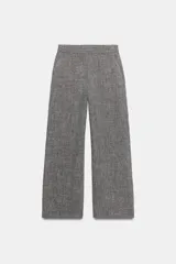 Pantalón gris melange de tiro alto y pierna ancha, con cintura elástica y bolsillos delanteros.