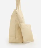 Cartera amplia confeccionada en fibra de papel, de color beige, con asas de hombro, cierre superior y detalle metálico dorado claro en el frente.