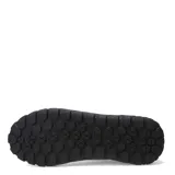 Zapatos Caterpillar modelo Hex + Cuero, color negro, estilo sneaker de caña baja con cordones. Presentan una capellada de cuero liso y textil, con suela de goma gruesa con patrón hexagonal en relieve. El logo Caterpillar en amarillo se encuentra en el lateral.