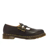 Zapatos Mary Jane Dr. Martens modelo 8065 Black Smooth, fabricados en cuero negro con doble tira ajustable mediante hebillas metálicas doradas, puntera con perforaciones decorativas tipo brogue y suela acolchada con costuras amarillas.
