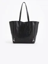Cartera tipo shopper de cuero vacuno flor graneado, con formato amplio y estructura flexible. Presenta dos cierres verticales decorativos en el frente con tiracierres personalizados y doble manija de hombro.