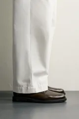 Zapato de vestir tipo derby, color marrón oscuro, con parte superior lisa, horma redonda, cordones y suela con ligero tacón.