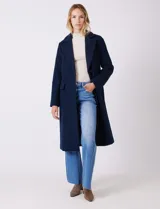 Tapado largo de lana Michael Kors, de corte recto y silueta estructurada. Presenta cuello con solapas amplias, cierre frontal con botones y bolsillos laterales con tapa. Incluye forro interno a tono.