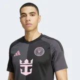 Camiseta de fútbol Adidas para hombre, modelo visitante del Inter Miami CF temporada 25/26. Diseño dividido verticalmente en dos tonos de negro/carbón, con detalles en rosa (logo Adidas, escudo del club y patrocinador principal con forma de ancla/corona).