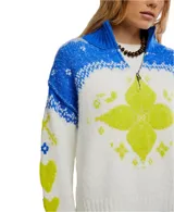 Sweater blanco con cuello alto y media cremallera, diseño holgado y extragrande. Presenta un patrón de punto jacquard en azul y amarillo neón, con motivos florales y geométricos. Los puños y el dobladillo son acanalados.