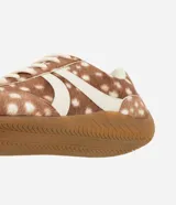 Championes Satinato con diseño de animal print tipo ciervo, confeccionados en cuero sintético con textura suave. Presentan recortes laterales en tono crema, cierre con cordones y suela de goma antideslizante.