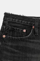 Short de denim tiro medio con trabillas, cinco bolsillos, diseño roto y bajo sin costuras. Cierre frontal con cremallera y botón metálico.