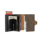 Billetera negra de cuero con caja de aluminio incorporada con sistema de deslizamiento para tarjetas, protección RFID, espacio para 5 tarjetas, sección para hasta 7 billetes y espacio adicional para libreta de propiedad y de conducir.