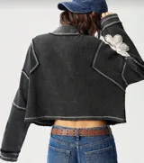 Sweater gris oscuro de punto waffle con cierre frontal, cuello alto y detalles de flores de encaje color crema en las mangas.