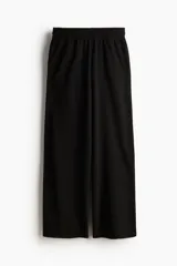 Pantalón jogging ancho de corte holgado en tejido de felpa, con tiro alto y cintura elástica fruncida. Piernas anchas con bolsillos laterales y un bolsillo trasero abierto.