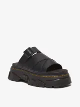 Sandalia negra de cuero con plataforma Mattison, suela híbrida de EVA y PVC con dibujo dentado, ranurado característico de Dr. Martens y costura amarilla. Cuenta con plantilla de espuma cubierta en gamuza y correa ajustable con hebilla.