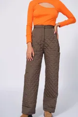 Pantalón largo color marrón con diseño acolchado y bolsillos laterales.