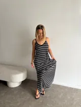 Vestido largo de jersey, color negro con rayas horizontales blancas, corte recto y tirantes finos.