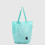 Bolso tipo tote de diseño minimalista y liviano, color turquesa, con costuras horizontales y doble asa de hombro. Incluye una etiqueta pequeña con el logo de la marca en la parte inferior.