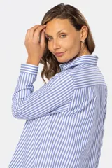 Camisa de manga larga con rayas verticales grises y blancas, corte holgado y bolsillo en el pecho.