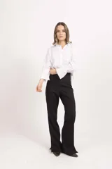 Pantalón sastrero de tiro alto y corte recto con caída amplia, confeccionado en tela de sastre color negro.