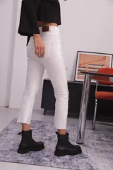 Pantalón blanco de bengalina engomada, corte capri semi oxford, tiro alto, bolsillos traseros, recorte a la altura de la rodilla y costuras a contratono.