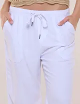 Pantalón crop de algodón y rayón, color beige, con pretina elástica con cordón de ajuste, bolsillos frontales aplicados y corte recto.