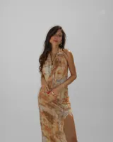 Vestido midi de microtul con forro interior, estampado abstracto en tonos tierra, escote halter y tajo lateral en la falda.