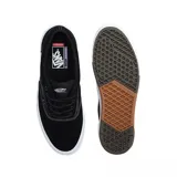 Championes Vans modelo Skate Era Wafflecup, color negro con suela blanca de plataforma y detalles en goma marrón. Presentan diseño de caña baja, cierre con cordones y costuras reforzadas.