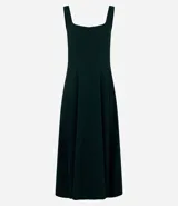 Vestido midi de corte evasé, color verde oscuro, con escote cuadrado, breteles anchos y recortes verticales que definen la silueta.