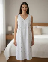 Camisón de algodón blanco, largo hasta la rodilla, sin mangas y con cuello en V abotonado. Presenta un estampado de finas rayas verticales azules y pequeñas formas de hojas azules dispersas.